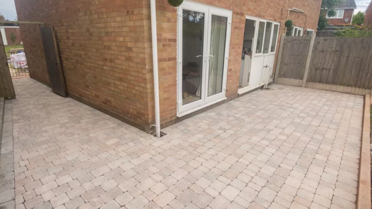 A spacious rear patio laid to block, doors facing adjacent