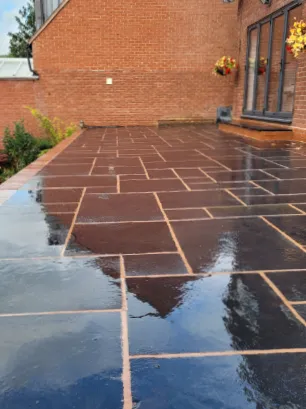 A high contrasting patio laid to dark slabs